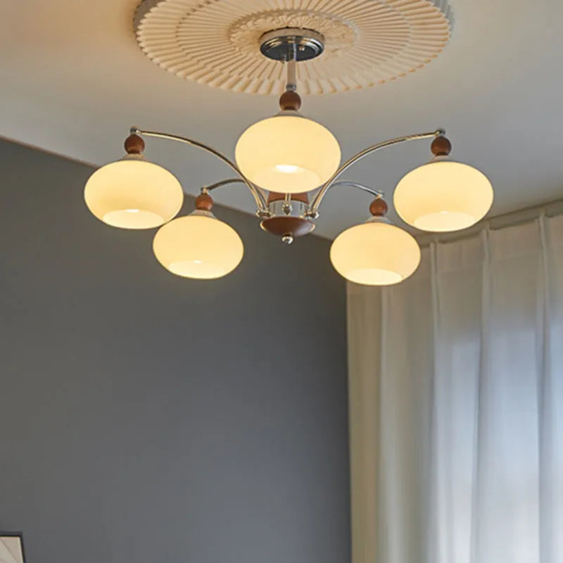 Traditional persimmon glass and chrome chandelier with multiple light heads for a dining room.