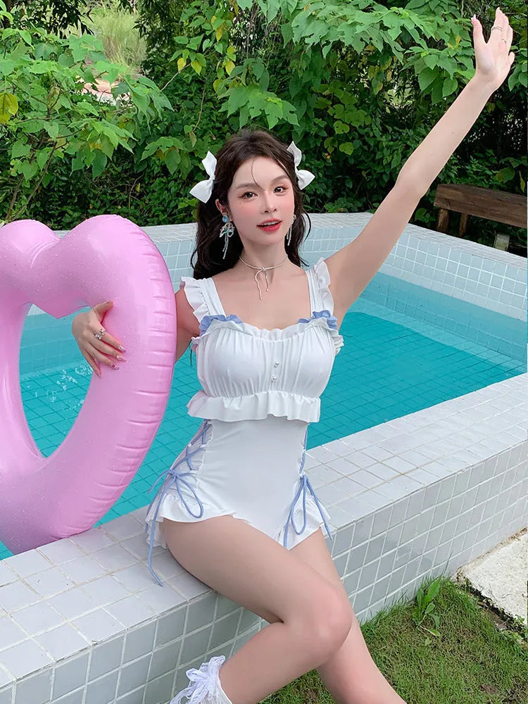 Milky white backless one-piece swimsuit on a hanger