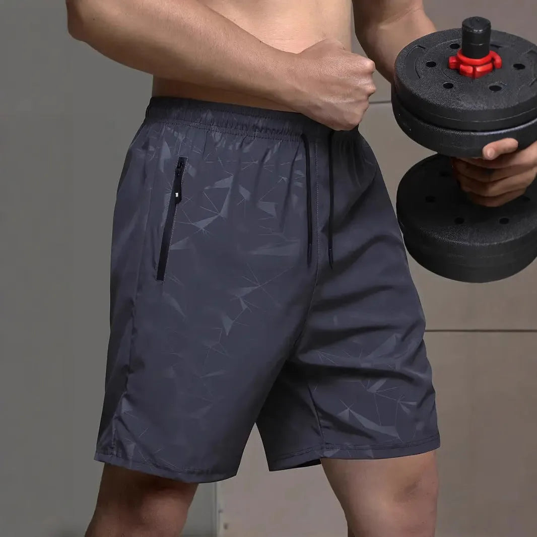 Man wearing loose grey printed sports shorts on a beach