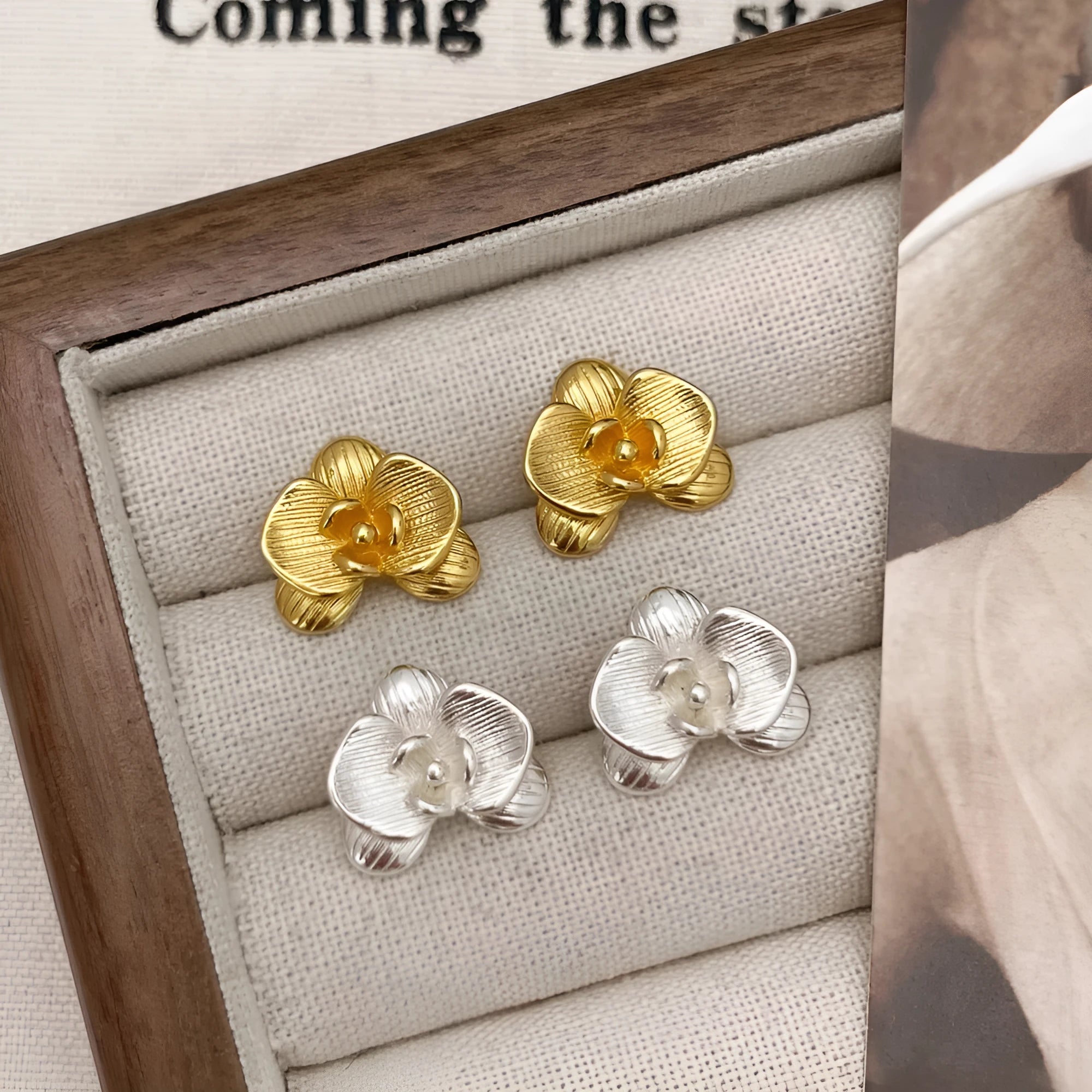 Retro flower earrings in gold or silver with detailed petal design on copper base