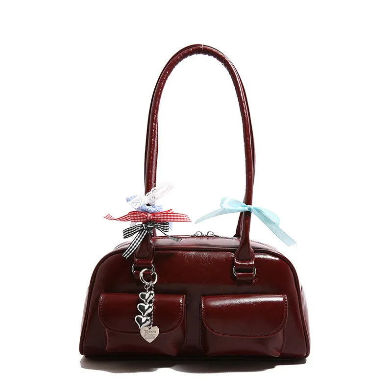 Retro pillow-shaped leather women's handbag with one shoulder underarm design in black with ribbon pendant