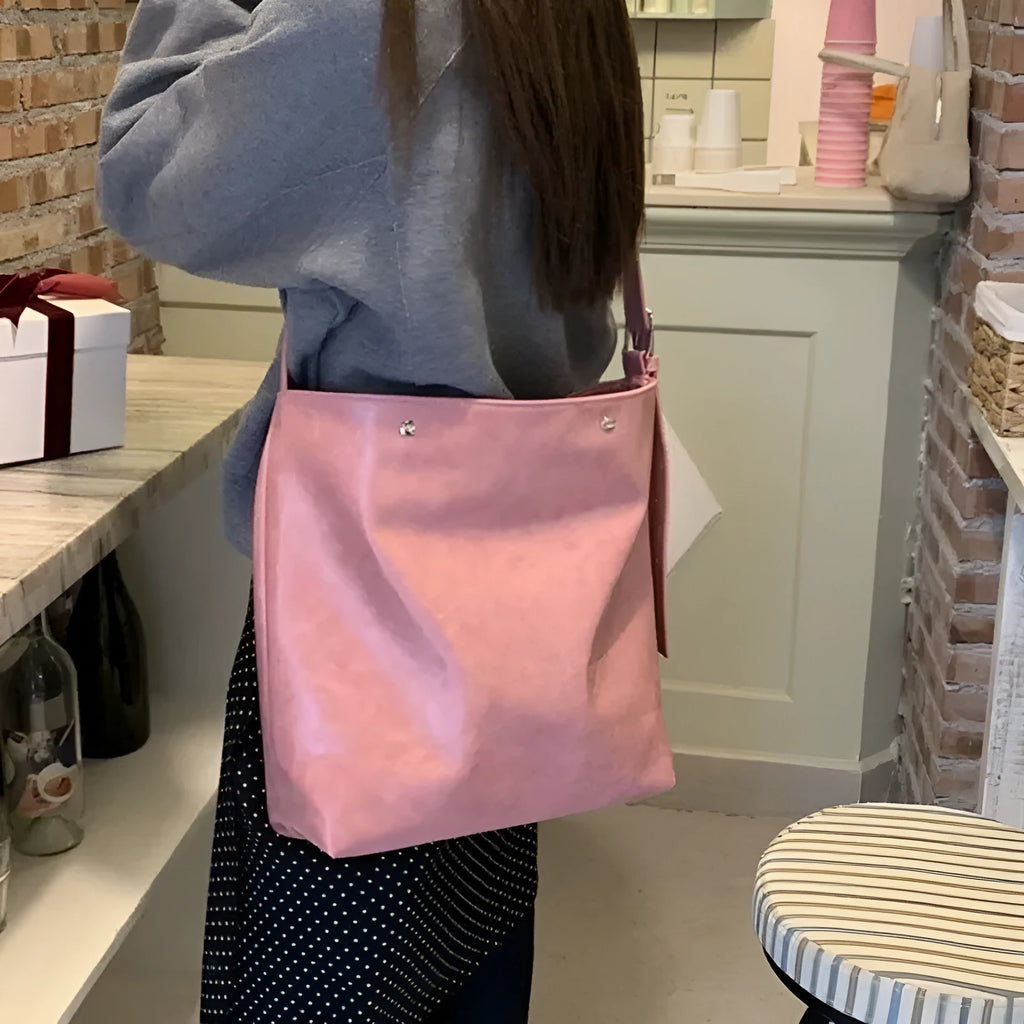 Pink or brown corduroy one-shoulder commuter bag showing dimensions.