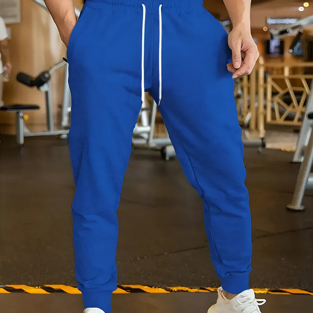 Men's loose-fit casual trousers with an elastic drawstring waist in a neutral colour.