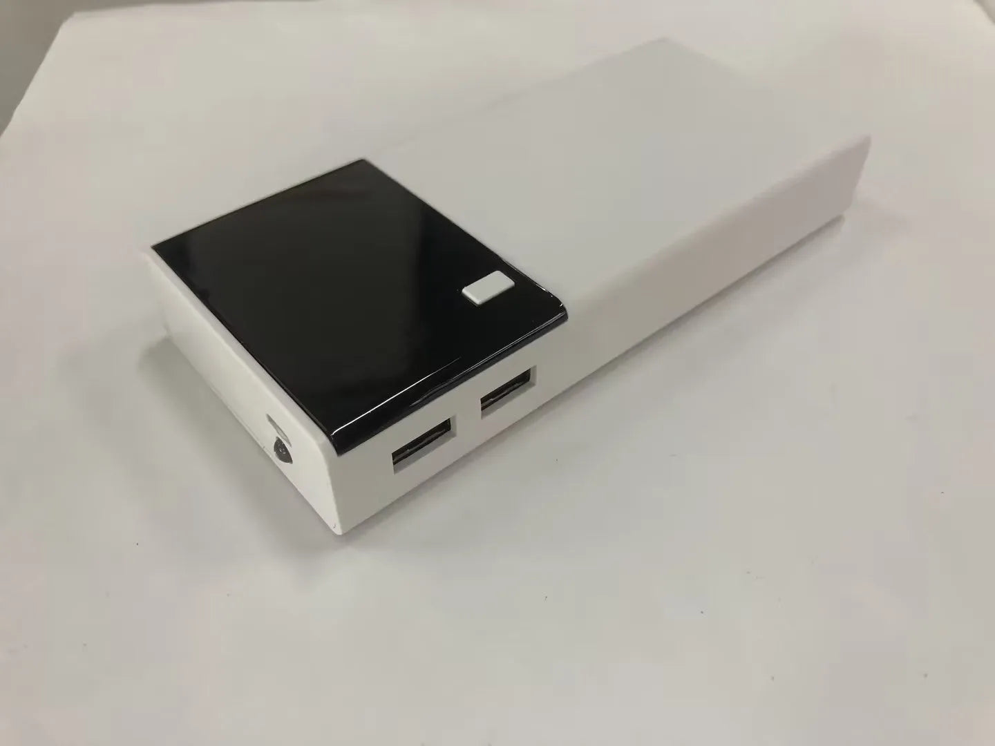 Black rectangular 20000mAh portable power bank with included USB charging cable