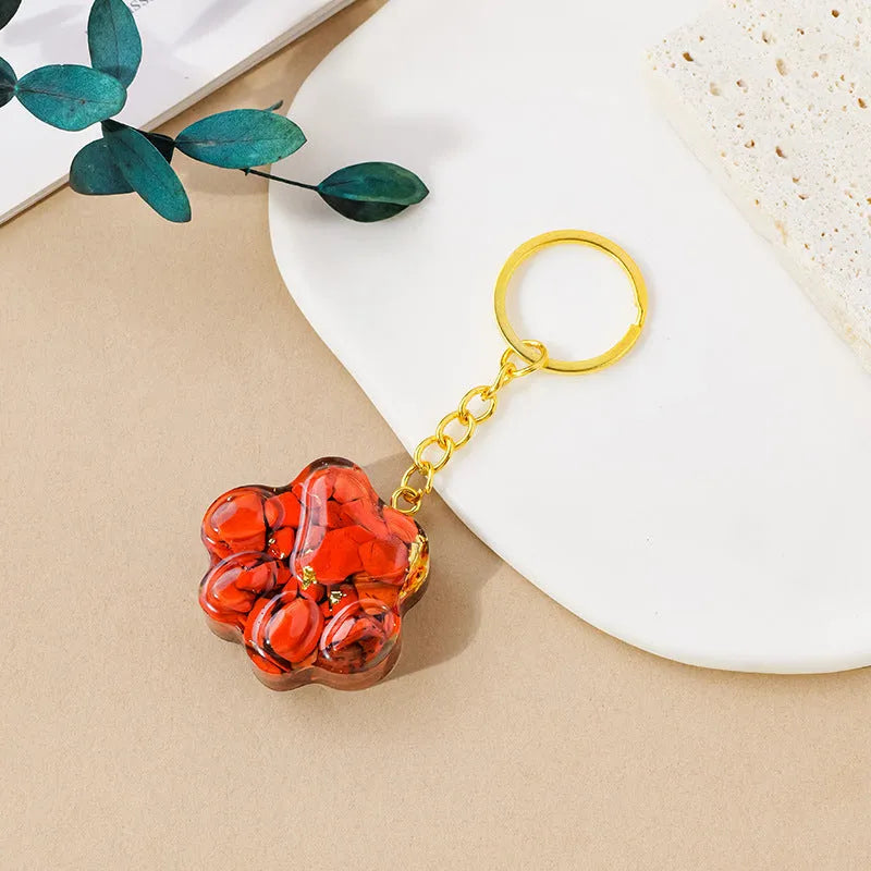 Natural crystal cat's paw shaped pendant on a silver keychain ring, shown in a random colour.