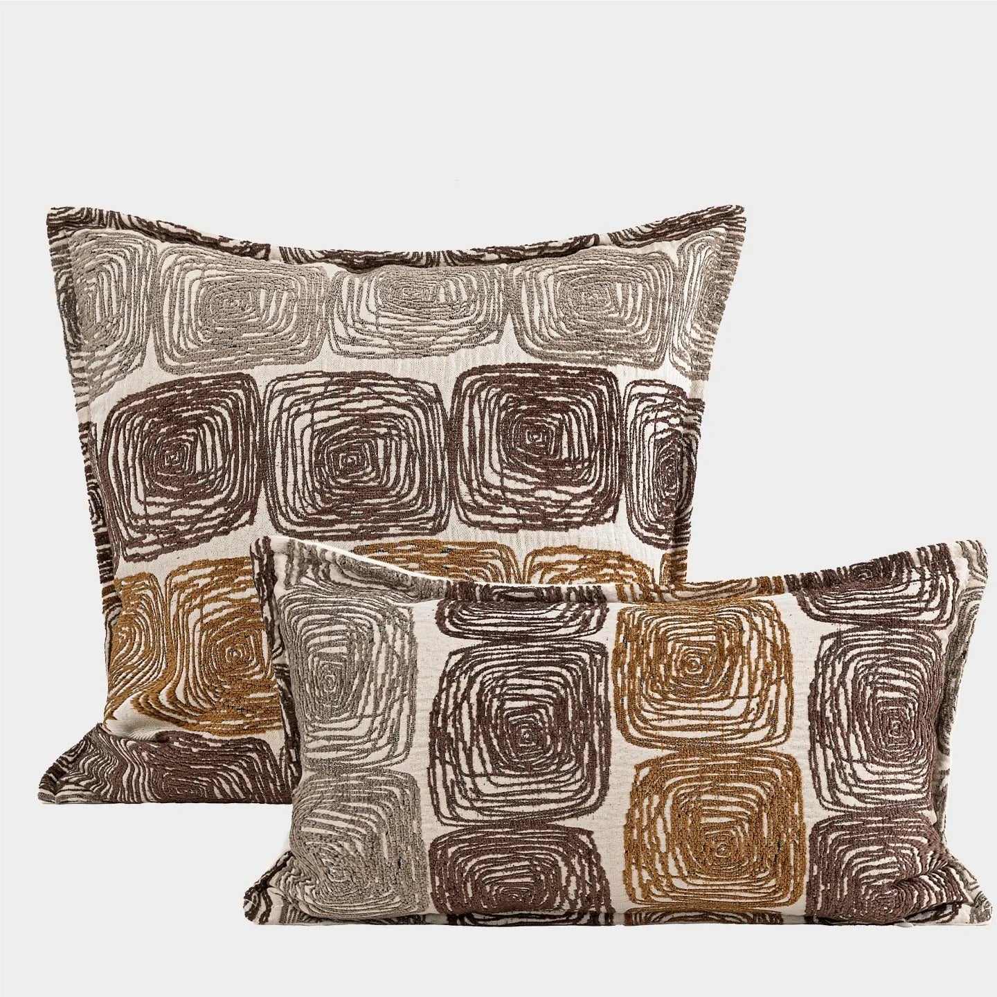 Cream and coffee-coloured abstract coil pattern on a square polyester pillow cover.