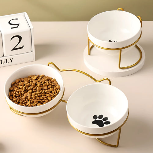 White ceramic pet bowl with cat paw print pattern in black iron frame stand
