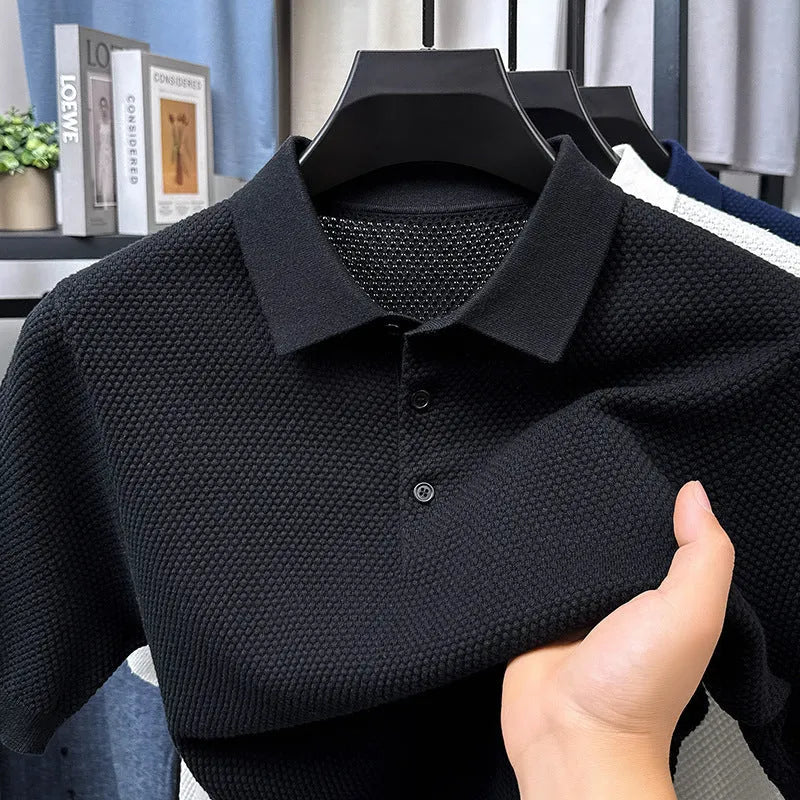 Man wearing a loose fit short sleeve cotton sweater in grey, showing the pullover style and relaxed silhouette.
