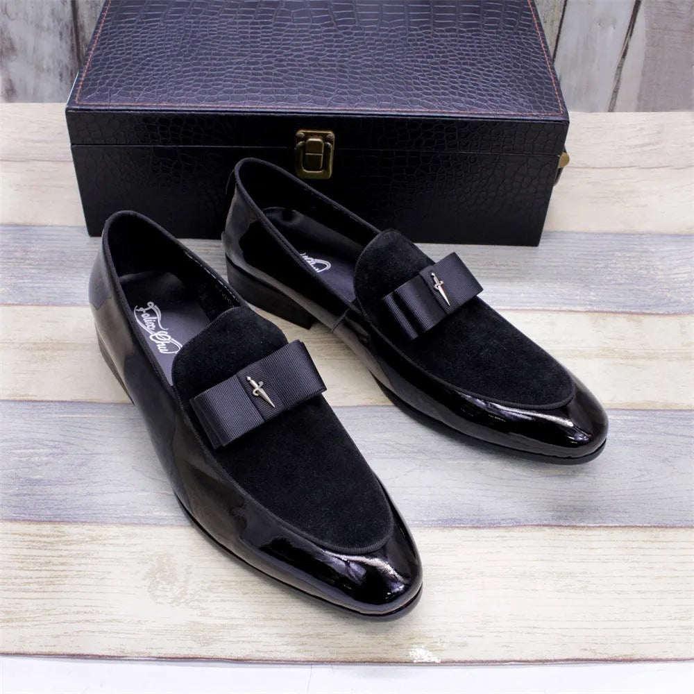 Men's black patent leather low-top shoes with a gold tassel detail and rubber sole.