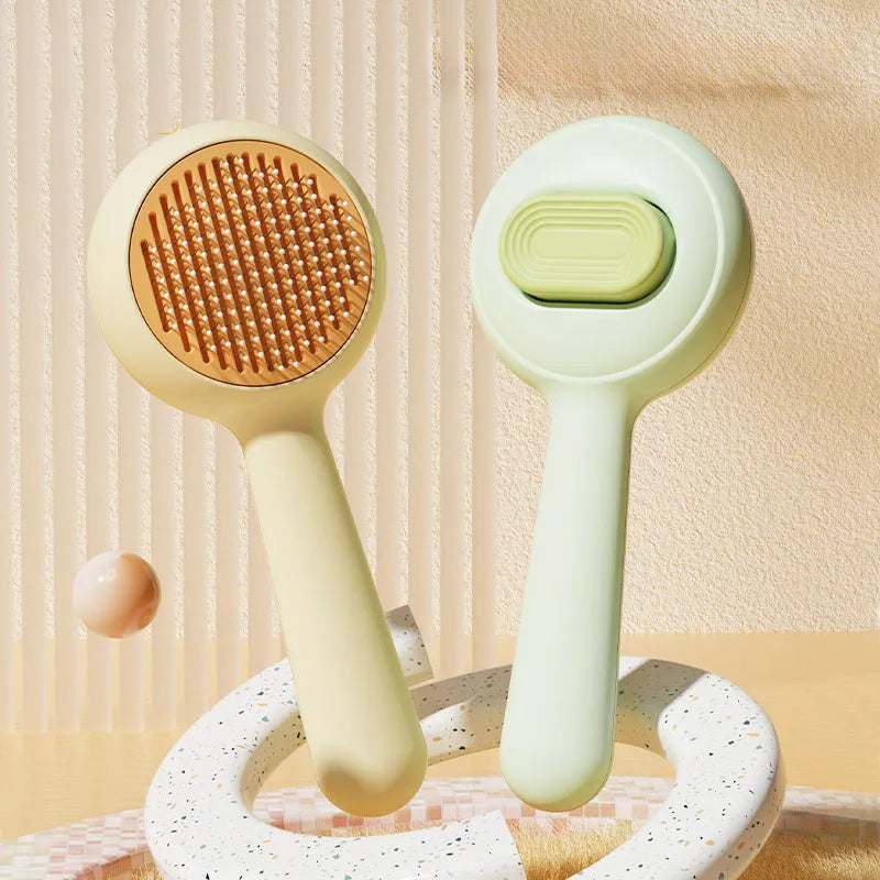 Green and yellow non-slip handle cat grooming brush with stainless steel comb teeth.