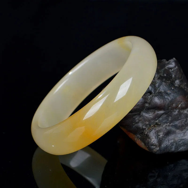Natural light jade Chinese style bracelet on a white background showing polished finish.