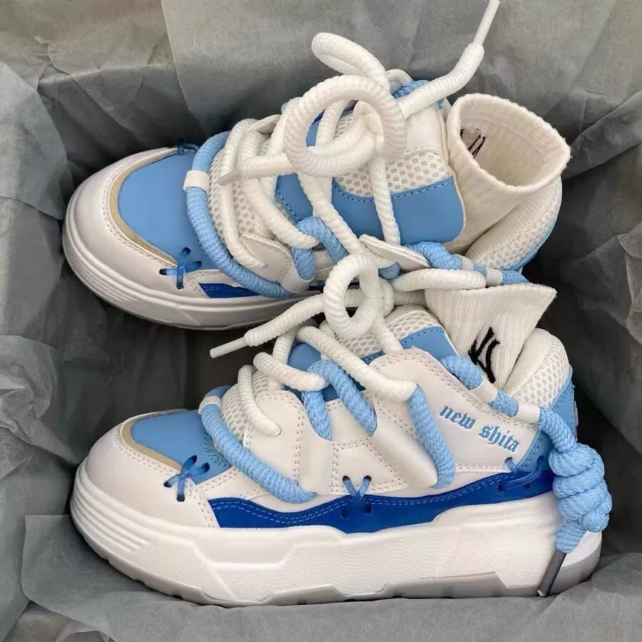 Women's thick bottom grey retro clunky sneakers with high heel on a white background.