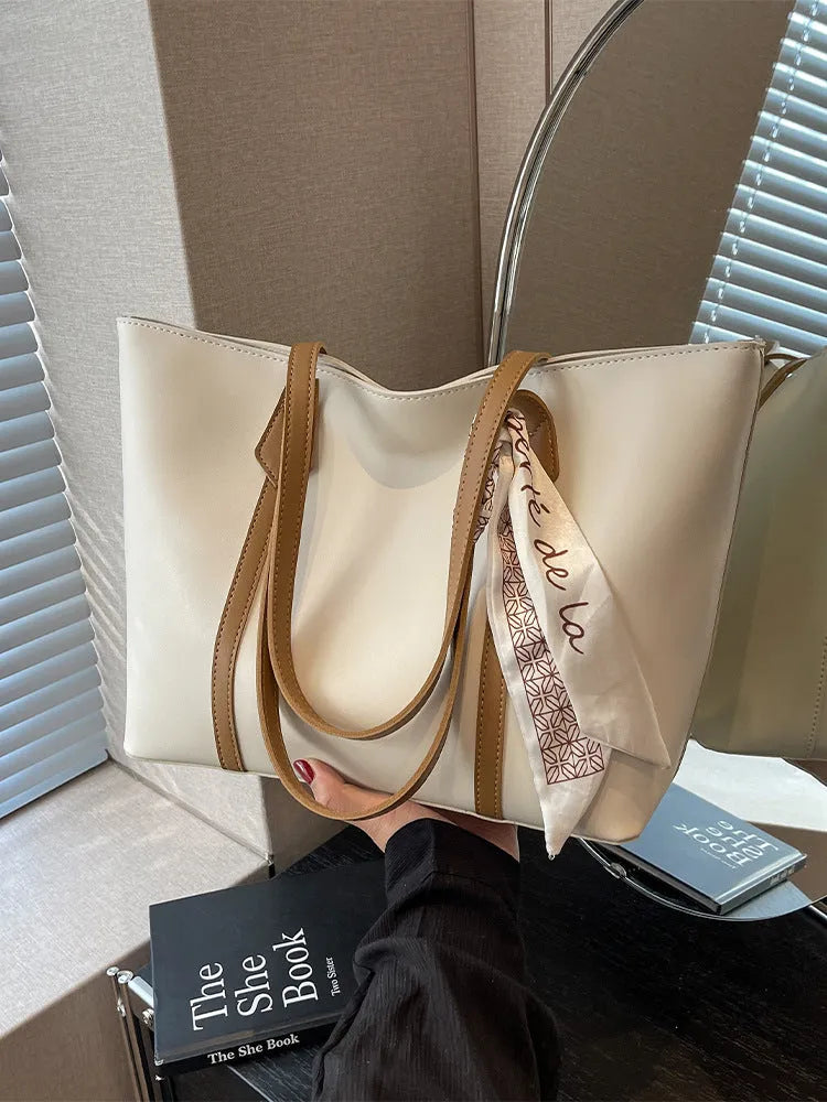 Soft large capacity tote bag with crossbody strap in khaki colour showing outer pocket and sewing line detail
