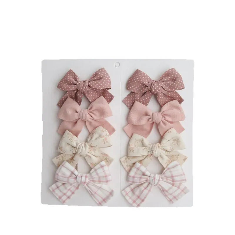Children's fabric dovetail bow hair clips in eight pattern options
