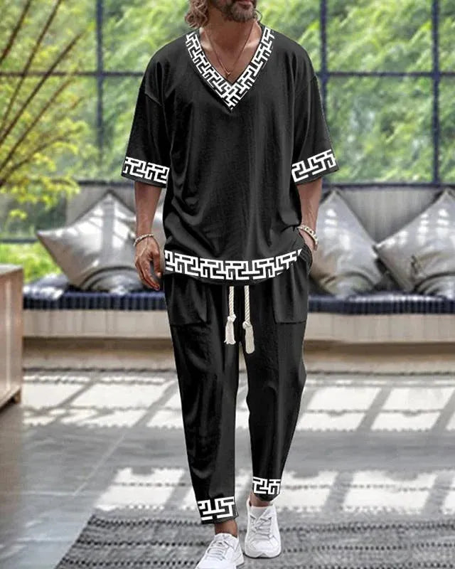 Cropped sleeve V-neck trousers suit set in thin polyester fabric on a hanger.