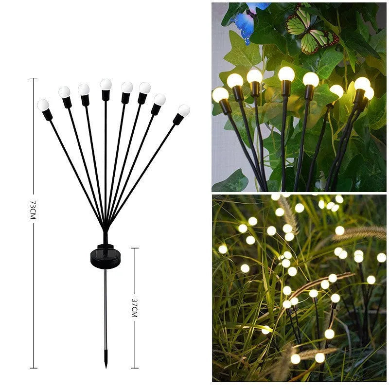 Solar-powered LED garden ground light with stainless steel spike inserted in lawn showing automatic dusk-to-dawn operation