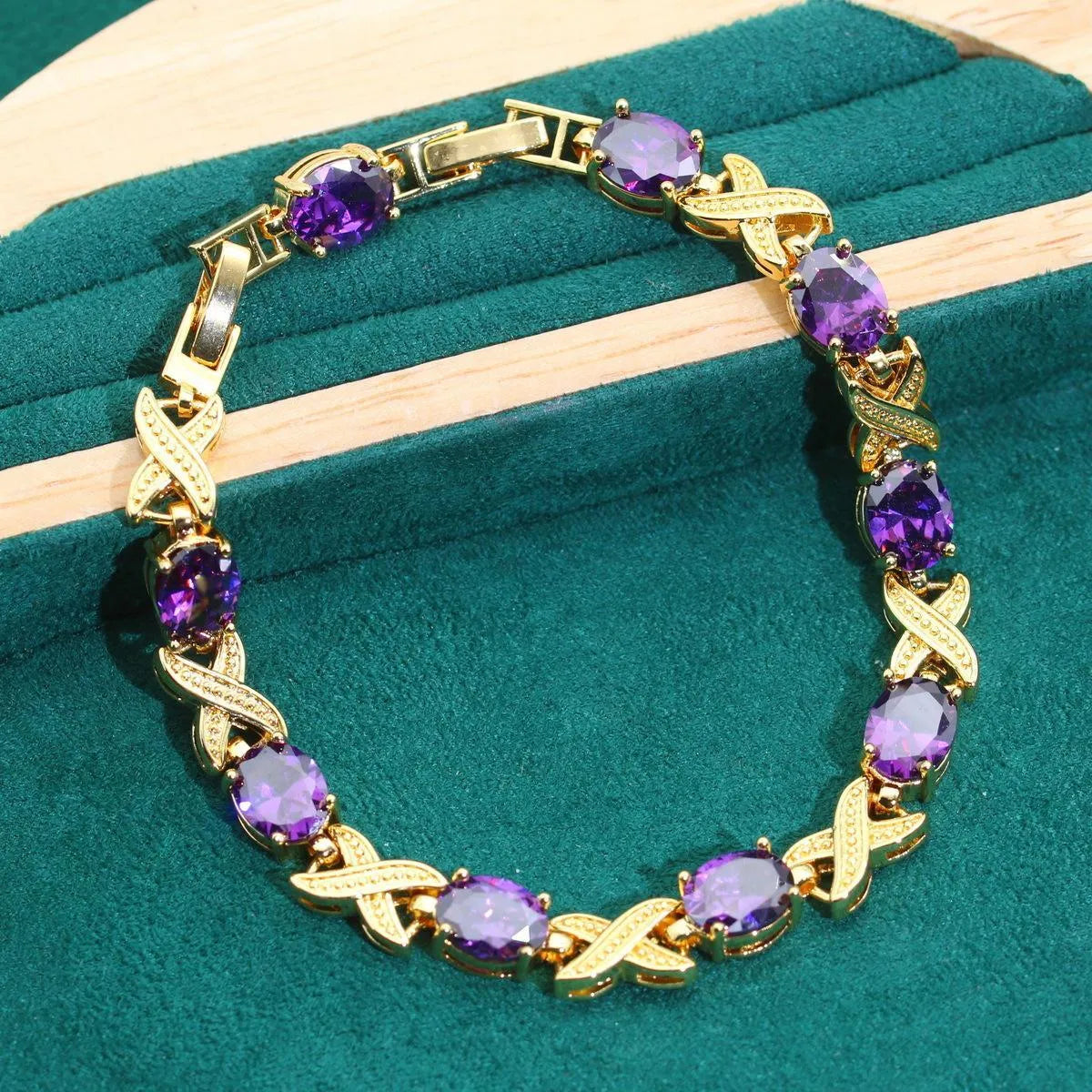 Gold plated jewellery set with multi-colour cubic zirconia stones, featuring a necklace, earrings, a ring, and a bracelet.