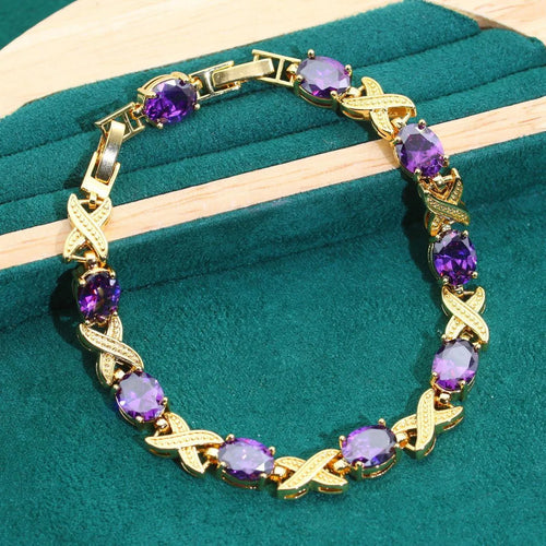Gold plated jewellery set with multi-colour cubic zirconia stones, featuring a necklace, earrings, a ring, and a bracelet.