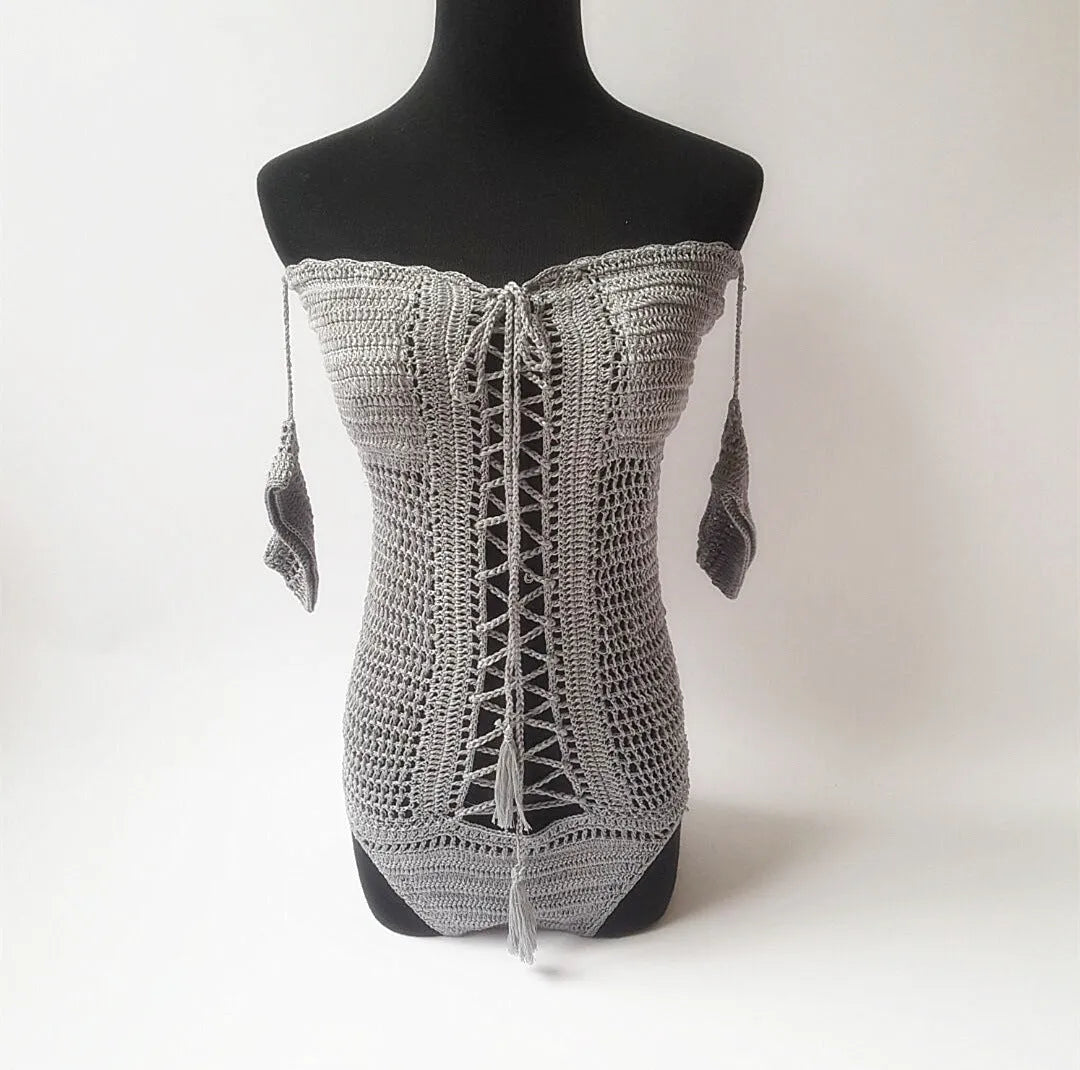 Off-shoulder one-piece swimsuit on a mannequin in light pink colour.