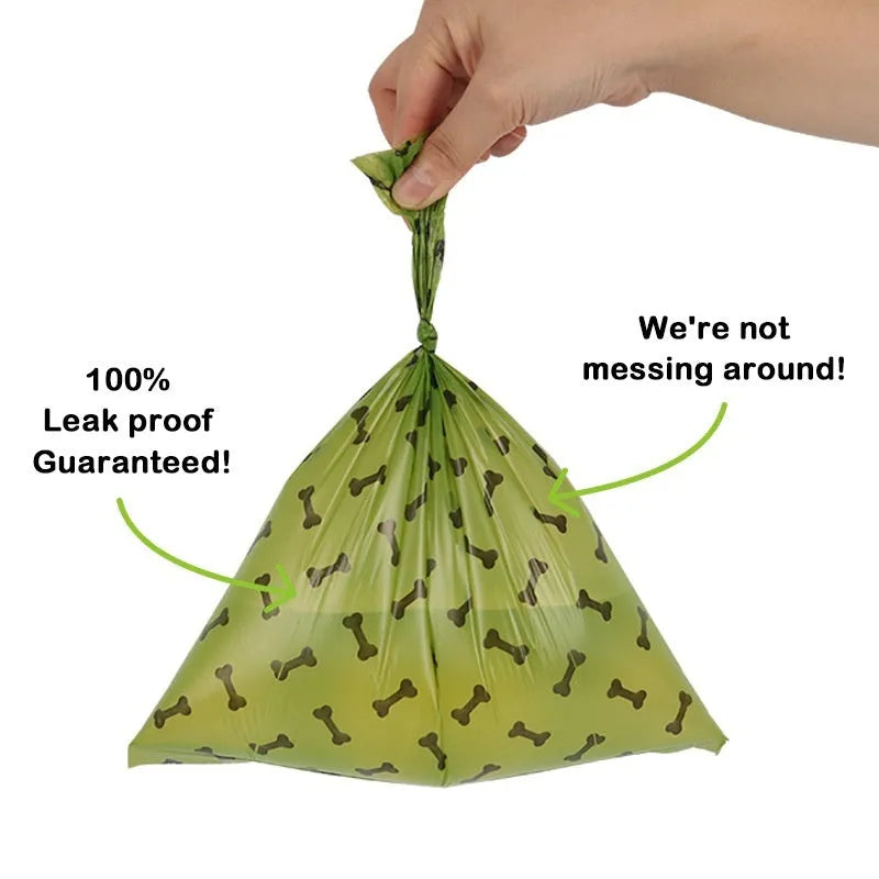 Roll of army green degradable dog waste bags with black bone print, showing bag size and dispenser.