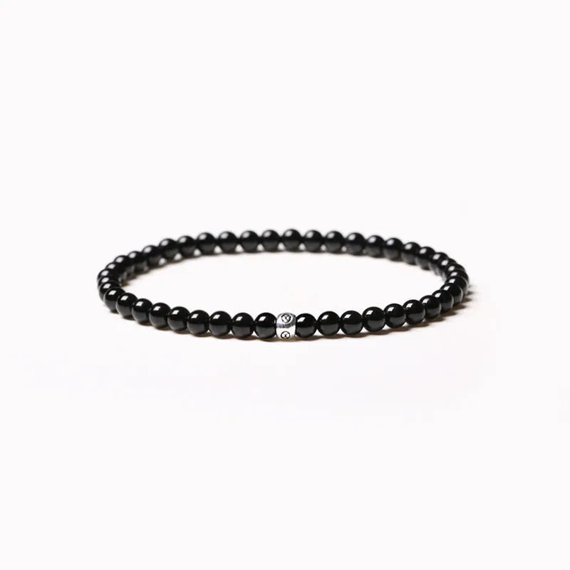 Fine geometric agate bracelet with round and square 4mm beads in obsidian, blue san, and black agate colours.