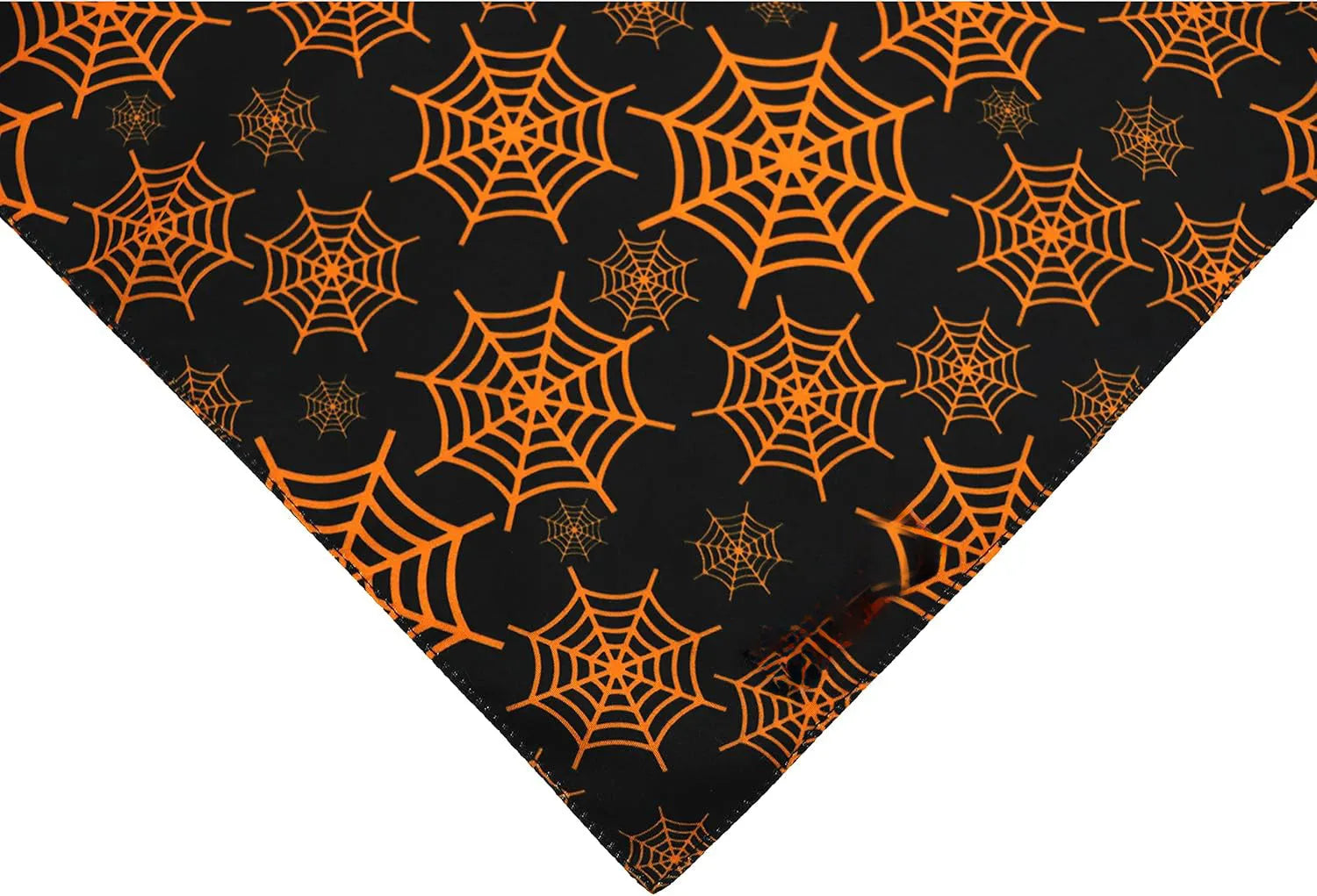Halloween dog bandana showing reversible pumpkin and spider web patterns with adjustable neck closure