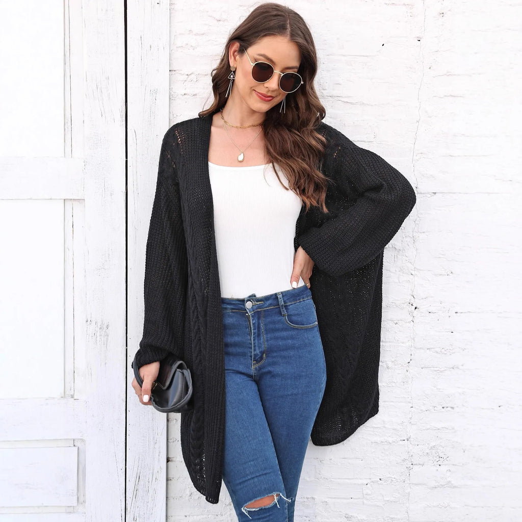 Women's loose brown acrylic sweater coat hanging on a hanger