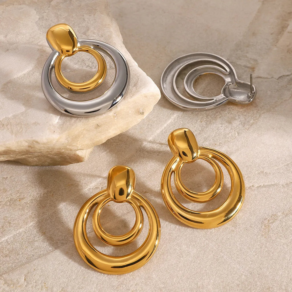 Round double layer hollow stud earrings with gold electroplated surface on titanium steel