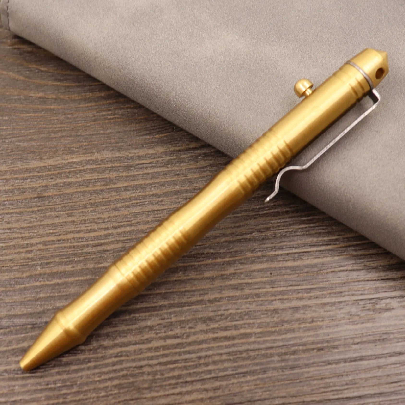 Brass tactical pen with bolt-action mechanism and retro brushed finish