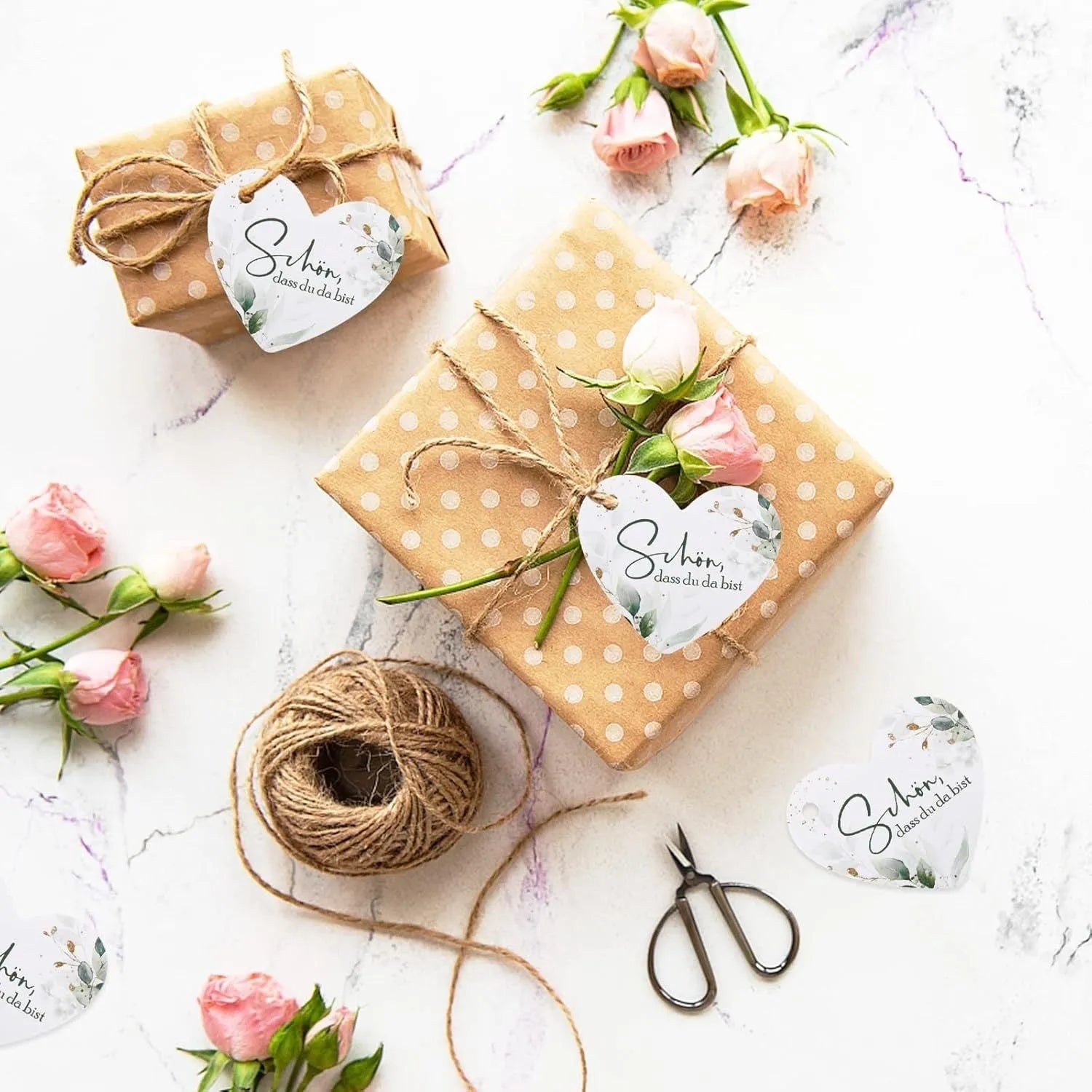 Pack of 50 flower heart-shaped paper gift tags in two decorative styles.