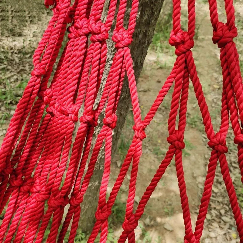 Outdoor nylon rope mesh hammock showing bold weave style, displayed with included tying ropes.