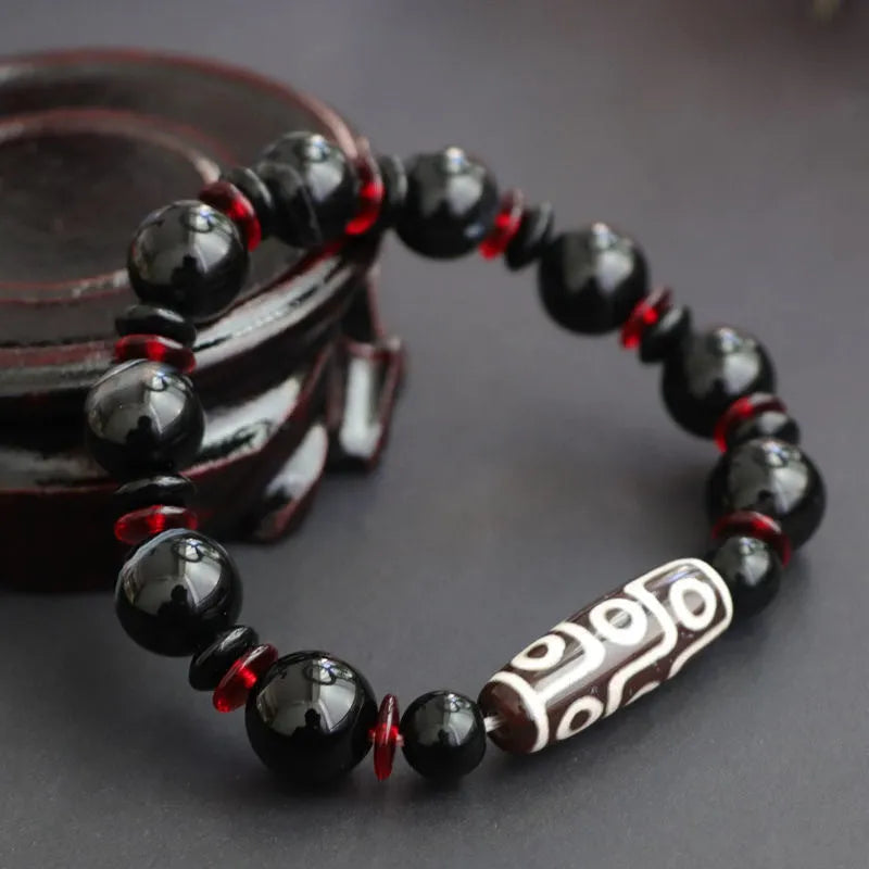 Black agate dzi bead bracelet with geometric pattern and hand-woven construction