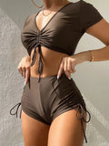 Women's lace-up bow two-piece swimsuit set in black, showing top and shorts