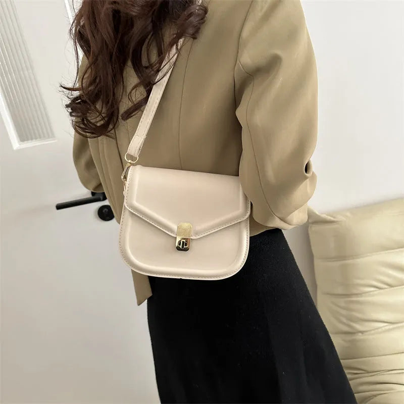 Soft textured PU shoulder messenger bag in horizontal square clamshell design.