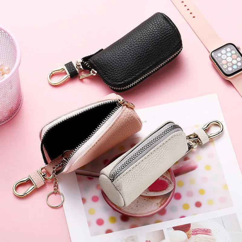 Minimalist black PU leather zippered key case for men, shown closed with a silver zipper.
