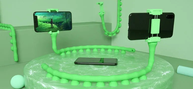 Flexible worm design mobile phone holder with suction cup mounted on desktop showing 360-degree rotation
