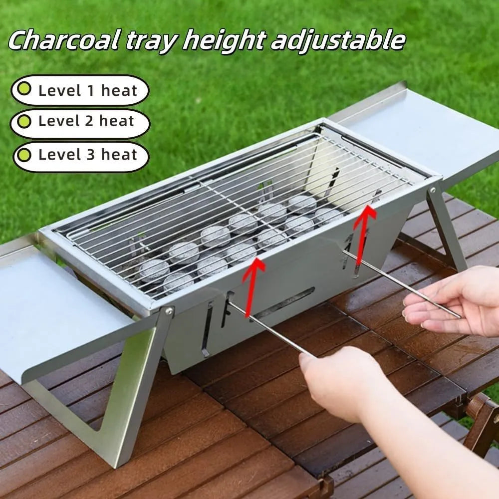 Small foldable portable charcoal grill shown in an outdoor setting