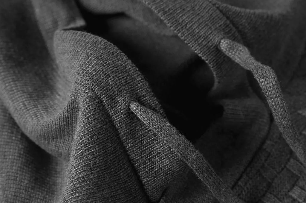 Men's black cotton-polyester blend hooded sweatshirt laid flat, showing front design and hood.