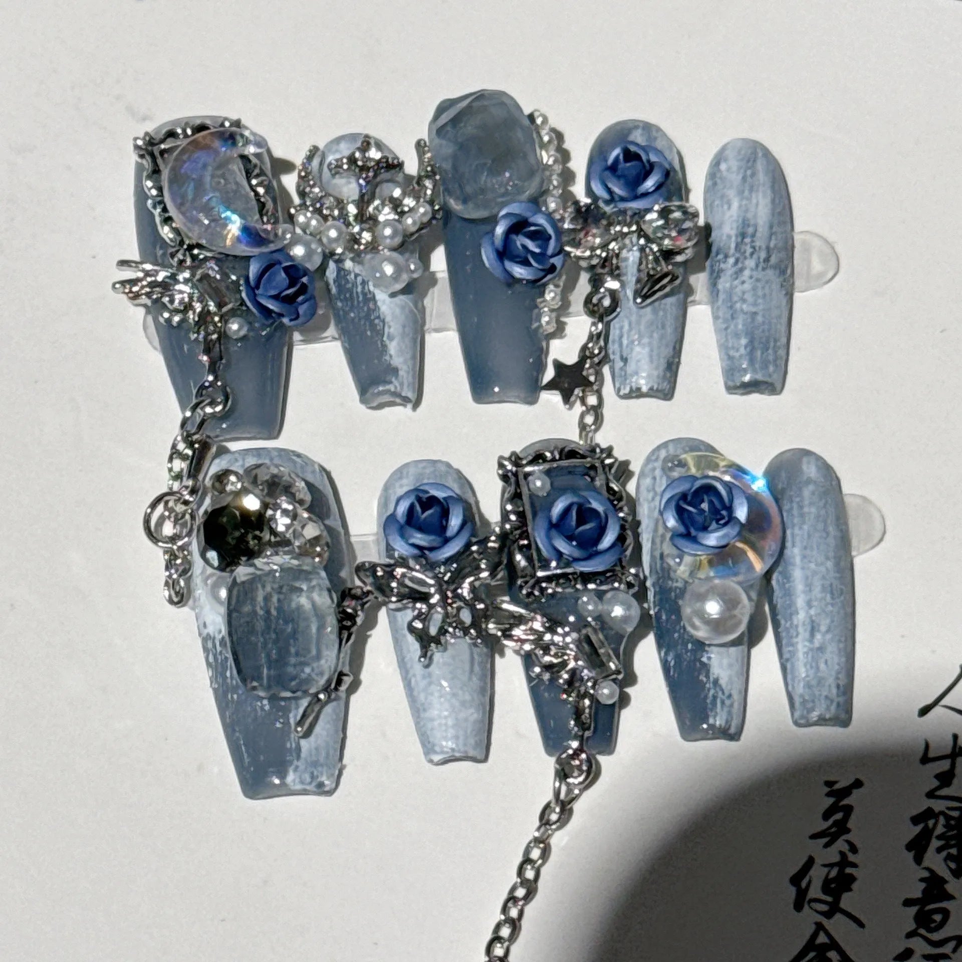 Wearable plastic nail armour suit in heavy industry night blue with ornate rose and tulip floral pattern.