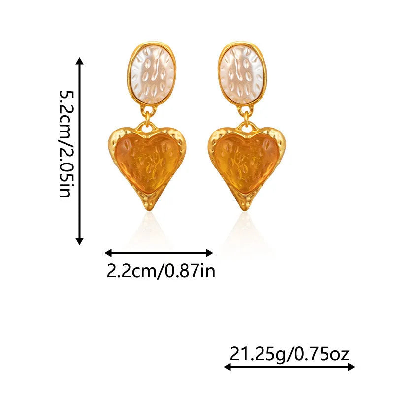 A pair of pleated oval love heart stud earrings in alloy, showing the silver needle post.