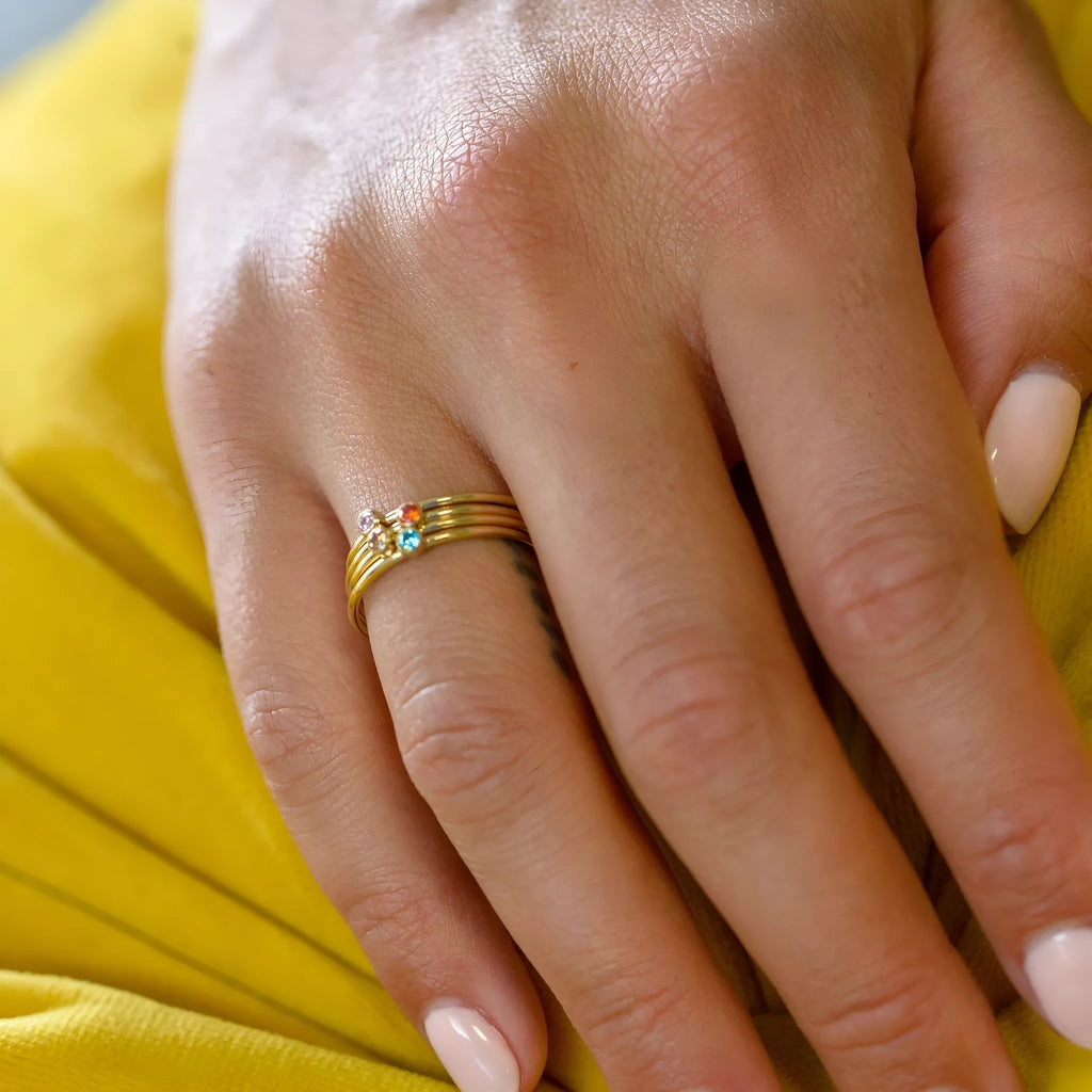 December birthstone titanium steel ring with geometric design and electroplated gold and steel finishes.