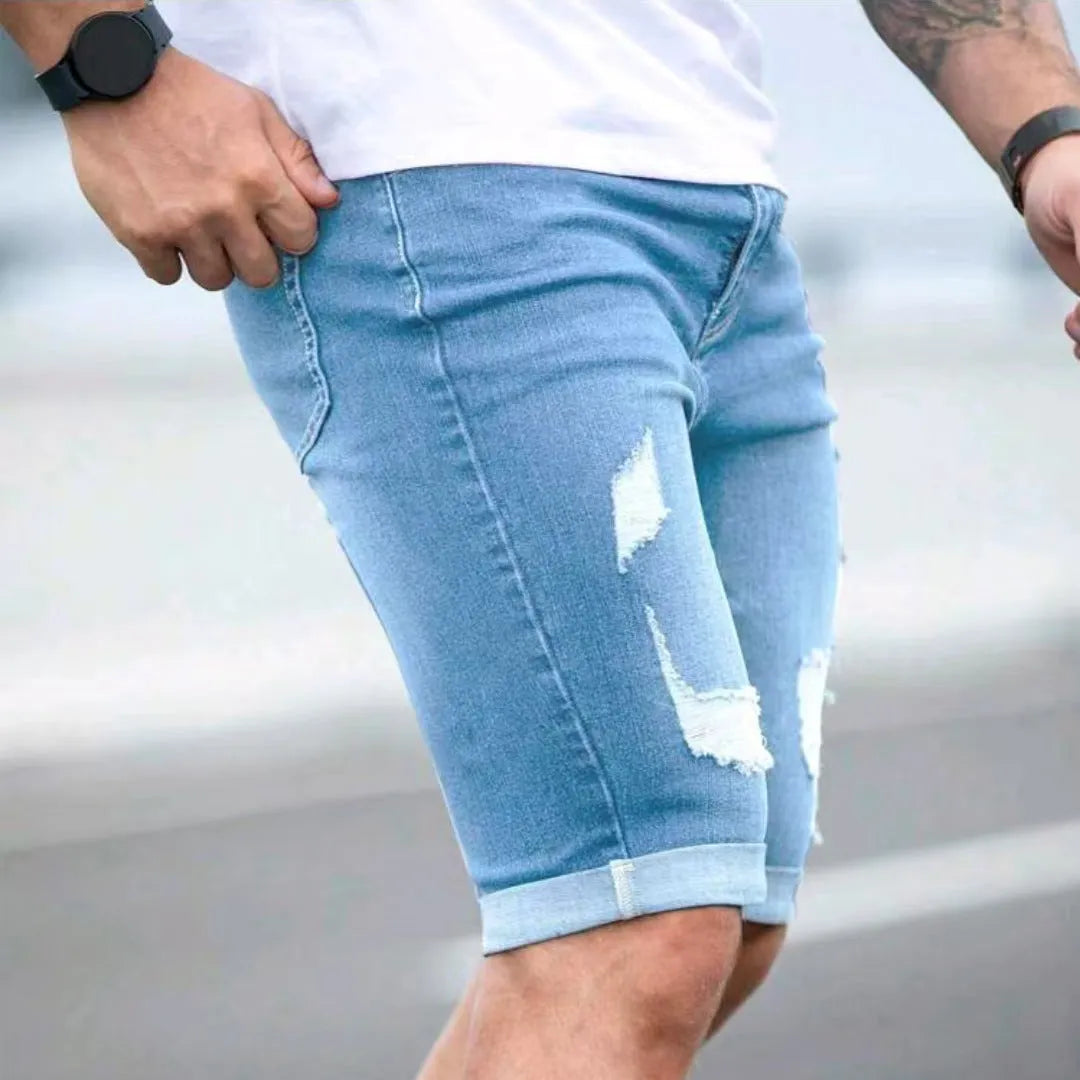 Sky blue men's denim shorts with a multi-hole distressed design and a straight leg.