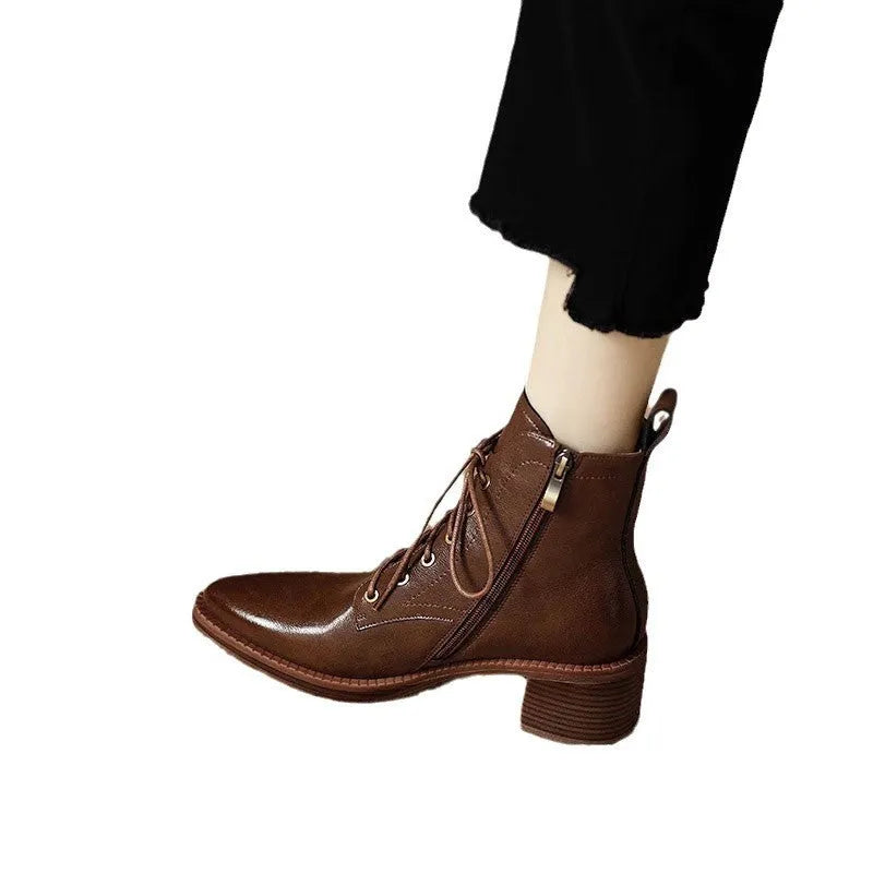 Women's black pointed-toe short ankle boots with a 5.5cm heel on a plain background.