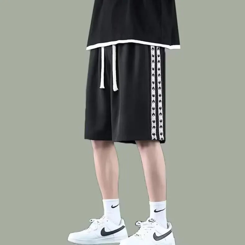 Men's loose fit track pants in black colour with elastic waistband and baggy leg cut
