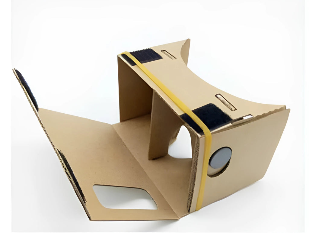 Pink and white folding cardboard VR glasses viewer for smartphones with 3D lenses and head strap.