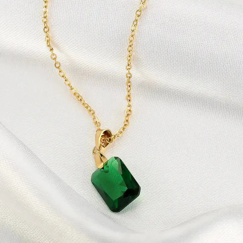 Copper geometric necklace with green rectangular quadrilateral pendant on an O-ring chain.