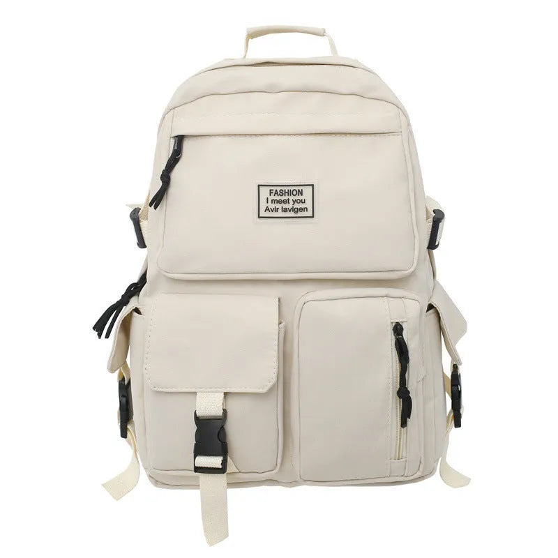 Black and white nylon student backpack with front 3D pockets, shown with laptop in compartment.