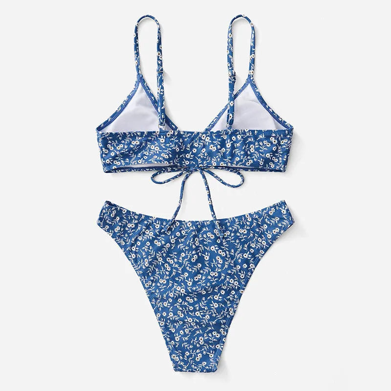 Blue women's three-piece swimsuit set with top and shorts on a white background.