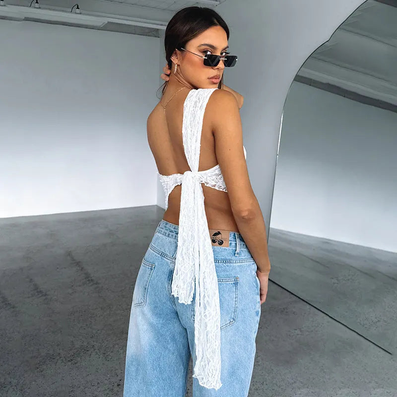 Womans lace backless vest top with asymmetrical sloped neckline in solid colour.
