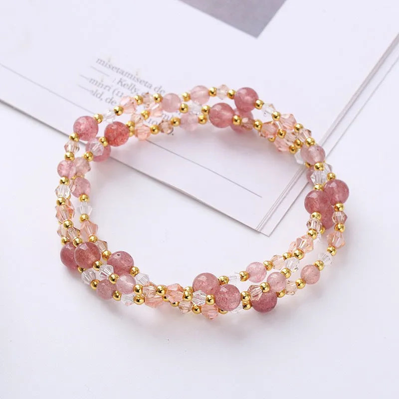 Women's three-ring crystal bracelet with tourmaline, strawberry quartz, and amethyst beads on adjustable cord.